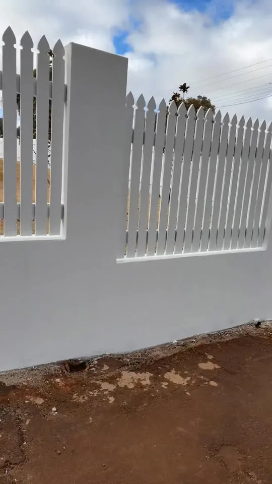 Freshly painted rendered wall and picket fence in Toowoomba